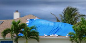 Storm damaged house with protective tarp